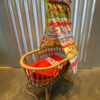 Rotan poppenwiegje met Stenzo kabouterstof. Verkocht.