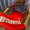 Rotan poppenwiegje met Stenzo kabouterstof. Verkocht.